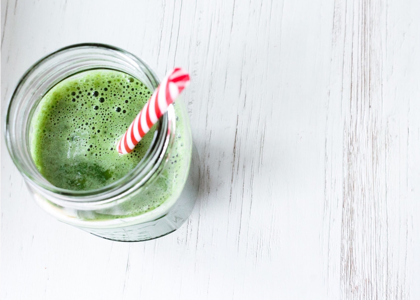 Green smoothie with red straw