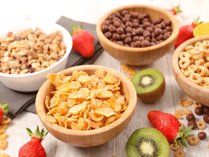 Four bowls of cereal and fruit